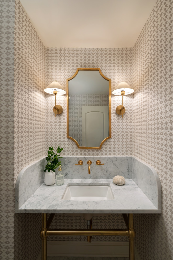 Design ideas for a mid-sized traditional powder room in Philadelphia with open cabinets, beige walls, marble floors, an integrated sink, marble benchtops, grey floor, white benchtops and wallpaper.