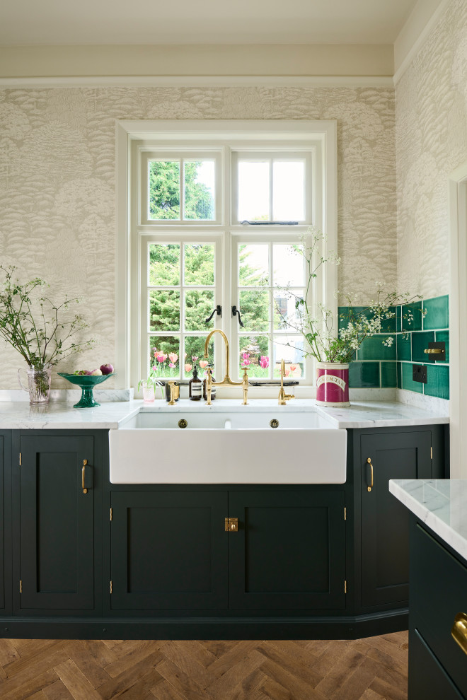 Design ideas for a large traditional eat-in kitchen in Other with a farmhouse sink, shaker cabinets, green cabinets, marble benchtops, green splashback, ceramic splashback, medium hardwood floors, with island and brown floor.