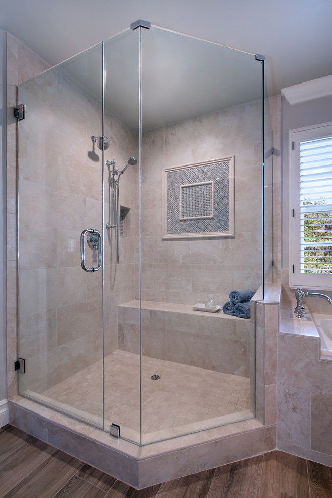 Example of a mid-sized transitional master beige tile and stone tile porcelain tile drop-in bathtub design in Orange County with shaker cabinets, white cabinets, a one-piece toilet, gray walls, an undermount sink and quartz countertops