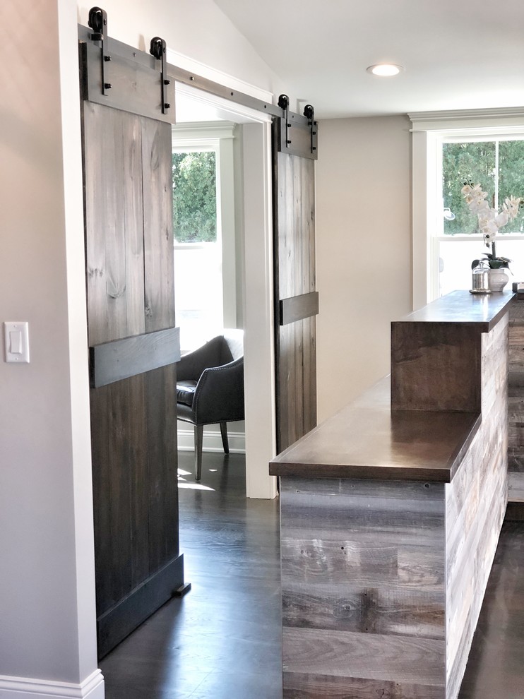Example of a mid-sized transitional dark wood floor and brown floor hallway design with gray walls