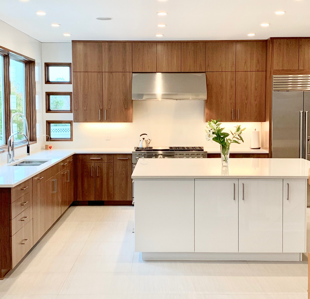 Design ideas for a large modern u-shaped eat-in kitchen in New York with a double-bowl sink, flat-panel cabinets, medium wood cabinets, quartz benchtops, white splashback, stone slab splashback, stainless steel appliances, ceramic floors, with island, grey floor and white benchtop.