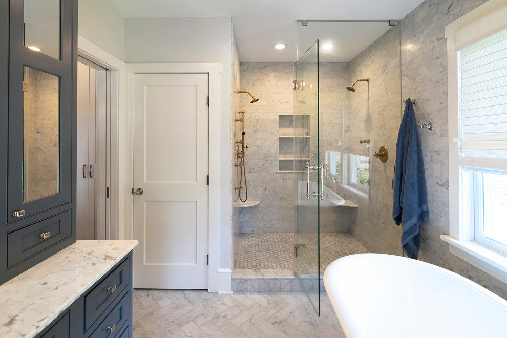 Mid-sized arts and crafts bathroom in Philadelphia with beaded inset cabinets, blue cabinets, a freestanding tub, a double shower, white tile, marble, grey walls, marble floors, an undermount sink, marble benchtops, white floor, a hinged shower door and white benchtops.