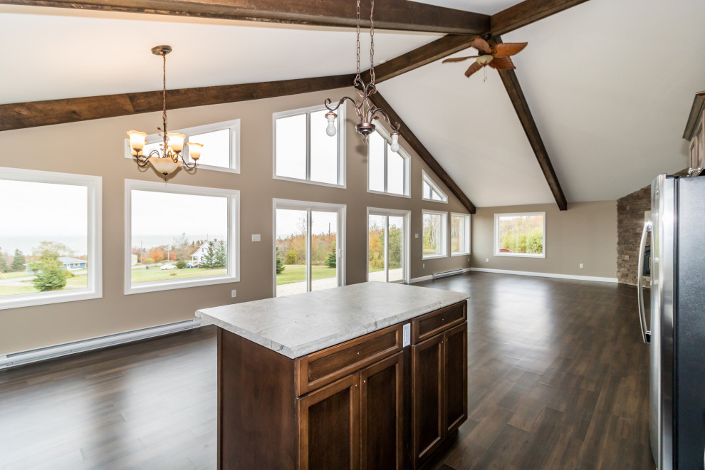 Mid-sized l-shaped brown floor and vinyl floor kitchen photo with dark wood cabinets, laminate countertops, stainless steel appliances, an island, multicolored countertops, a drop-in sink and recessed-panel cabinets