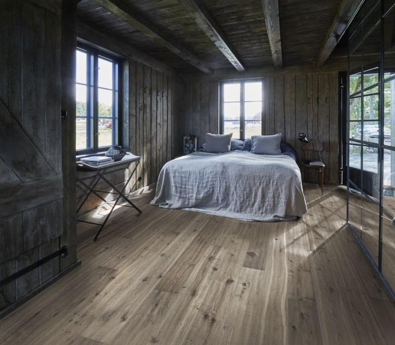 Photo of a country bedroom in Stuttgart with dark hardwood floors.