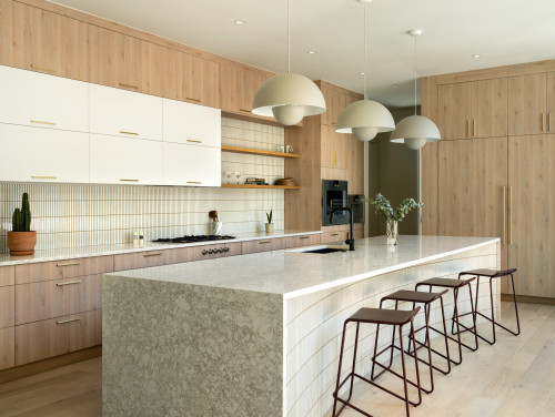 Close-up of modern white Kitchen Cabinet Mississauga drawers featuring sleek metal hardware and light wood countertops in a bright, renovated space
