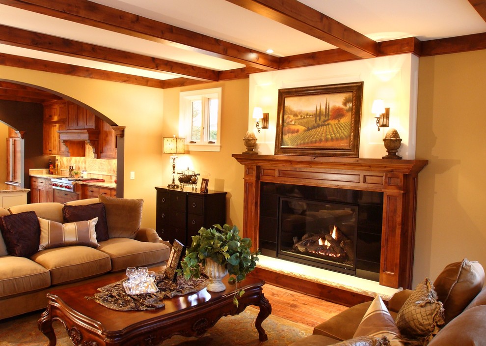 This is an example of a large traditional living room in Minneapolis with a standard fireplace and a wood fireplace surround.