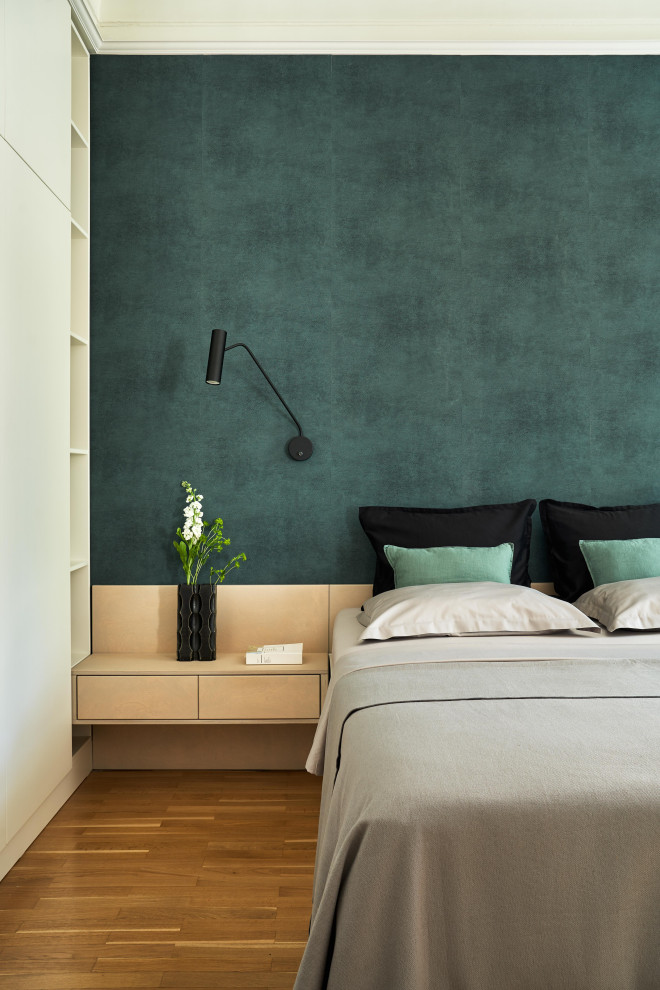 Inspiration for a mid-sized contemporary master bedroom in Saint Petersburg with green walls, medium hardwood floors, brown floor and wallpaper.