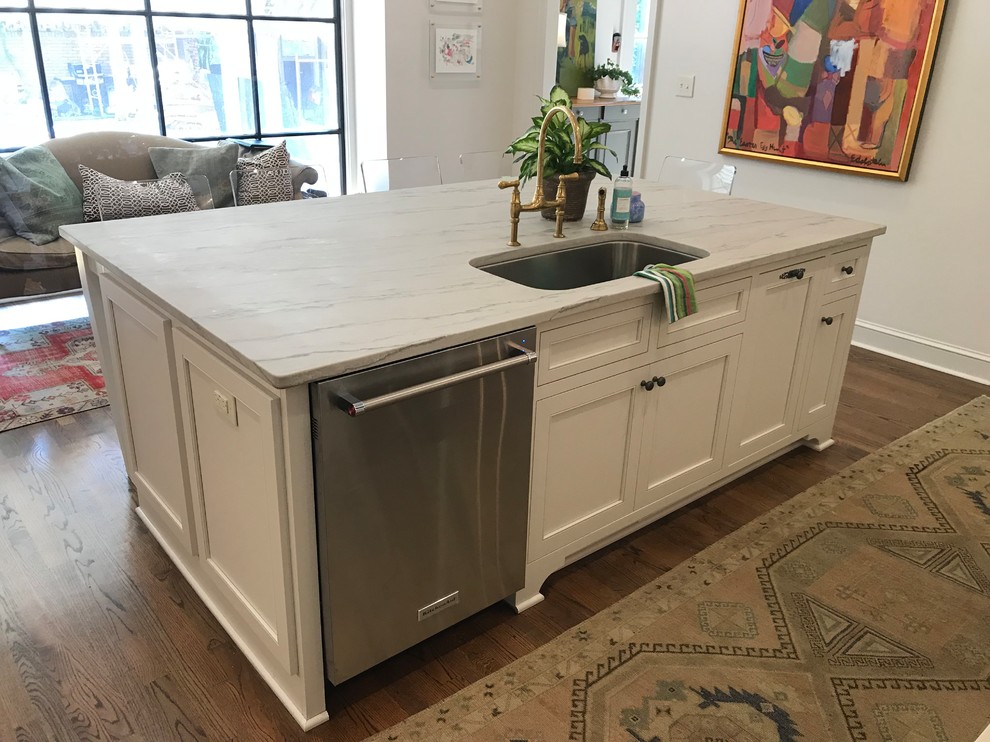 Eat-in kitchen - large transitional u-shaped dark wood floor and brown floor eat-in kitchen idea with an undermount sink, recessed-panel cabinets, white cabinets, marble countertops, white backsplash, subway tile backsplash, stainless steel appliances, an island and white countertops