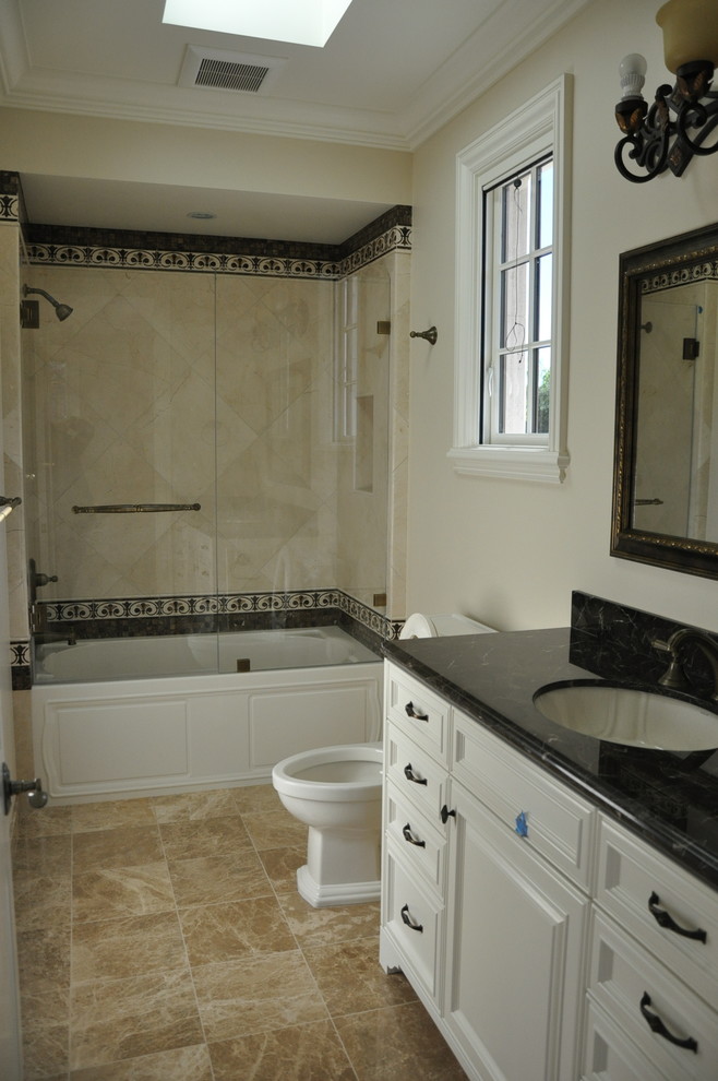 This is an example of a medium sized traditional family bathroom in San Francisco with an alcove bath, a shower/bath combination, beige tiles, marble tiles, beige walls, marble flooring, a submerged sink and engineered stone worktops.