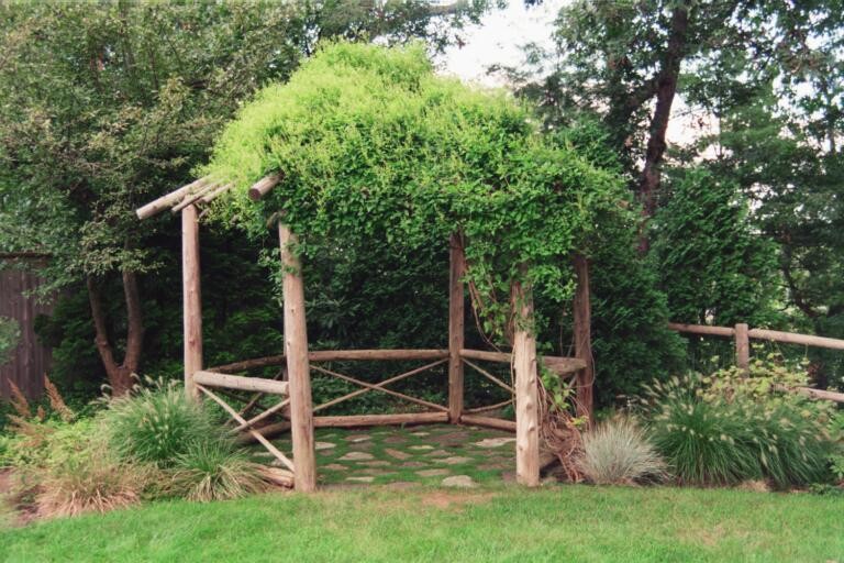 Inspiration for a large rustic partial sun backyard stone garden path.