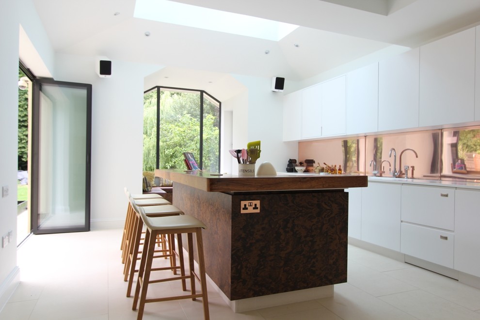 Inspiration for a large contemporary single-wall open plan kitchen in London with an undermount sink, flat-panel cabinets, dark wood cabinets, wood benchtops, stainless steel appliances, ceramic floors and with island.