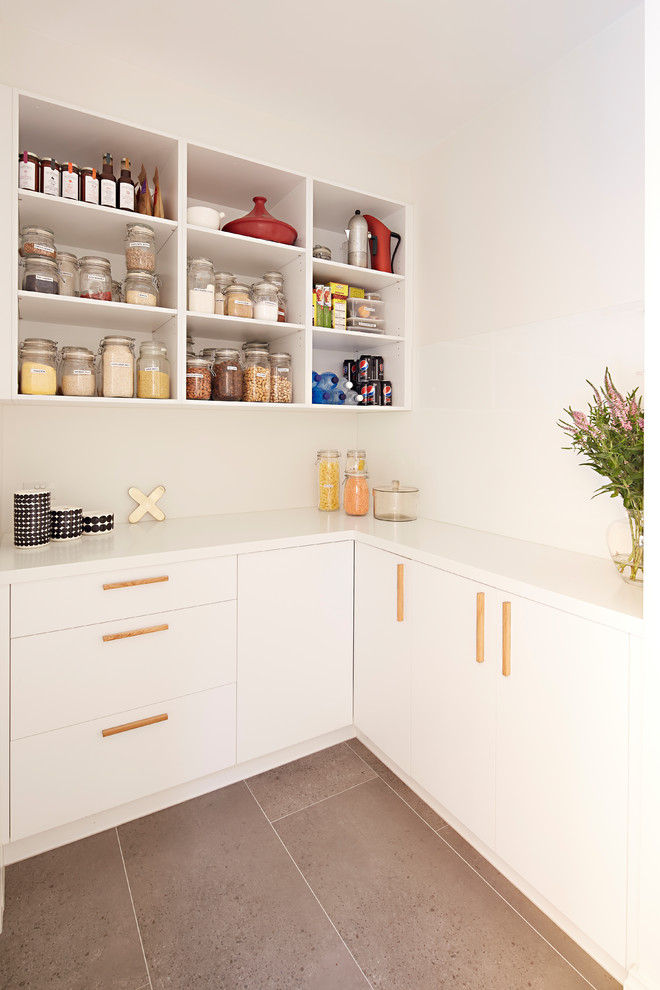 This is an example of a large beach style single-wall open plan kitchen in Melbourne with a double-bowl sink, beaded inset cabinets, medium wood cabinets, marble benchtops, stainless steel appliances, light hardwood floors, with island, brown floor and white benchtop.