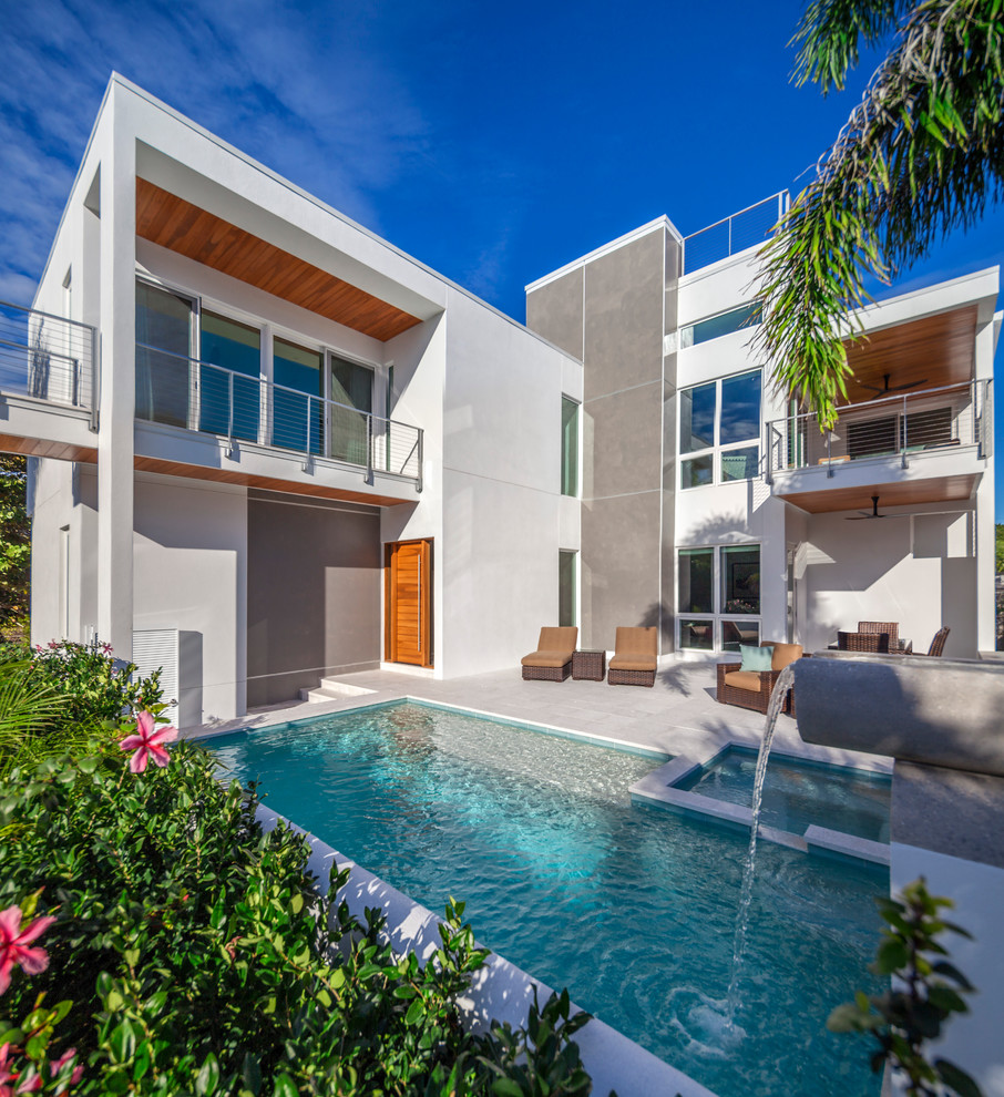 Design ideas for a contemporary stucco white exterior in Tampa.