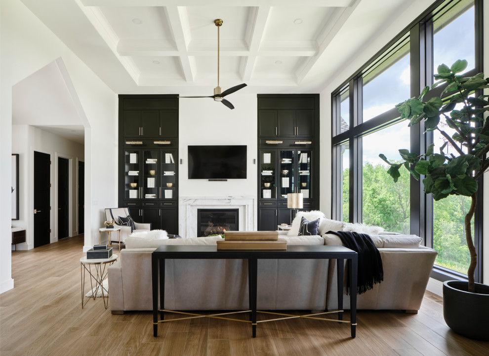 Inspiration for a large classic open plan living room in Omaha with white walls, porcelain flooring, a standard fireplace, a stone fireplace surround, a built-in media unit, beige floors and a coffered ceiling.