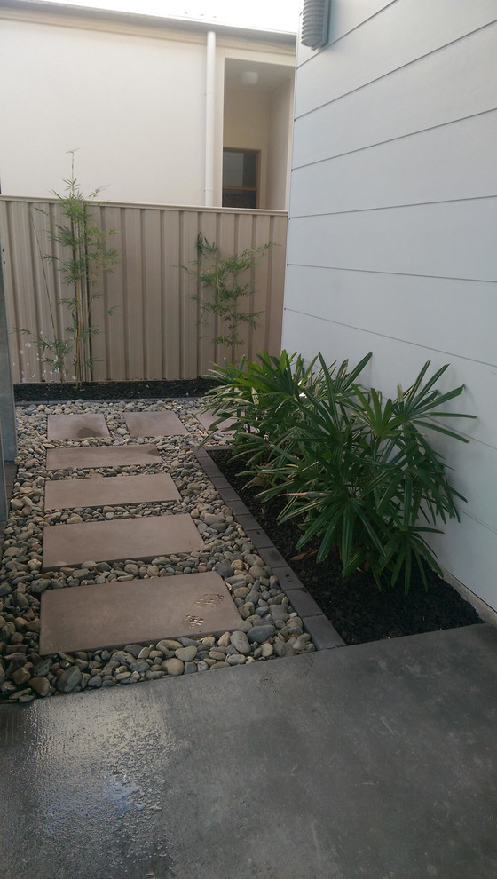 Australian native modern side yard shaded formal garden in Brisbane with concrete pavers.