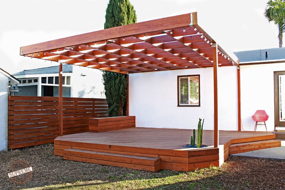 Photo of a mid-sized contemporary backyard deck in Los Angeles with an awning.