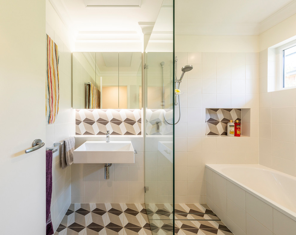 Design ideas for a small contemporary master bathroom in Canberra - Queanbeyan with glass-front cabinets, a drop-in tub, an open shower, a one-piece toilet, blue tile, ceramic tile, white walls, ceramic floors, a wall-mount sink, blue floor, an open shower, a single vanity and a floating vanity.