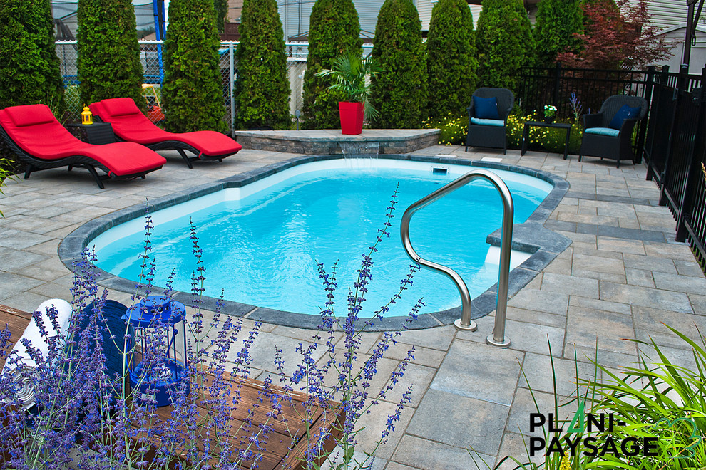 Inspiration for a mid-sized contemporary backyard pool in Montreal with concrete pavers.