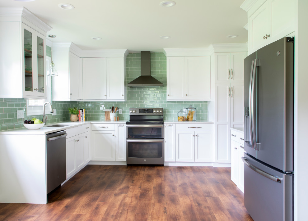 Transitional vinyl floor kitchen photo with an undermount sink, shaker cabinets, white cabinets, quartz countertops, green backsplash, glass tile backsplash, stainless steel appliances, no island and white countertops