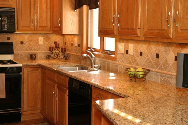 Transitional u-shaped medium tone wood floor kitchen pantry photo in Chicago with raised-panel cabinets, medium tone wood cabinets and granite countertops