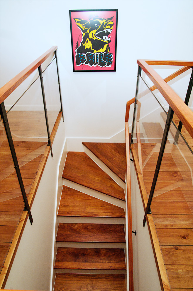 Photo of a mid-sized eclectic wood curved staircase in Boston with wood risers.