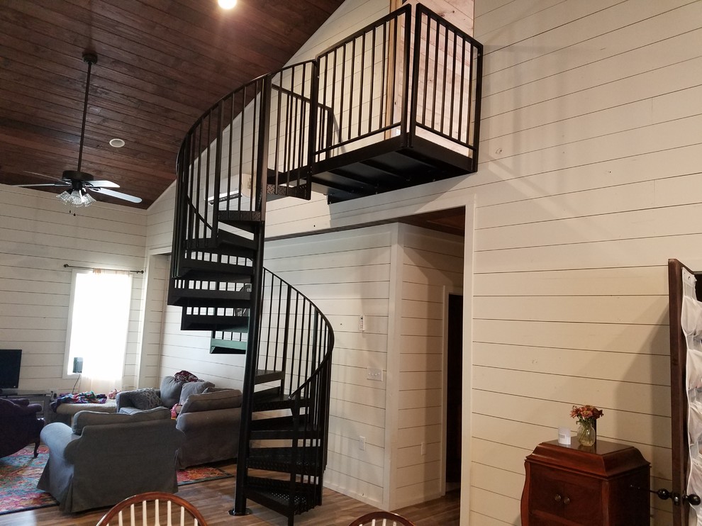 Design ideas for a mid-sized country metal spiral staircase in Wilmington with open risers and metal railing.