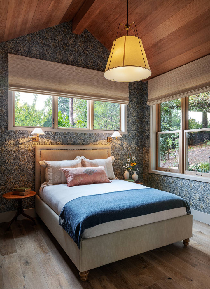 This is an example of a mid-sized country master bedroom in San Francisco with blue walls, medium hardwood floors and brown floor.