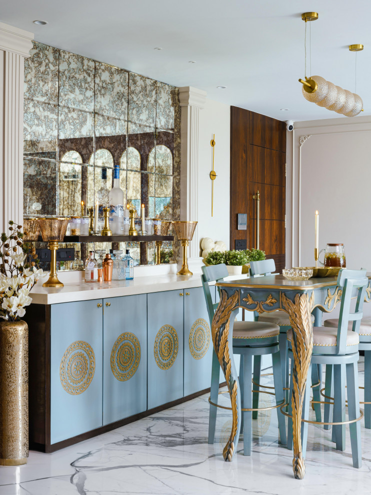 Inspiration for a large midcentury single-wall seated home bar in Mumbai with no sink, raised-panel cabinets, blue cabinets, solid surface benchtops, black splashback, mirror splashback, marble floors, white floor and white benchtop.