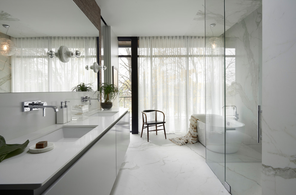 Large trendy master white tile and stone slab freestanding bathtub photo in Chicago with an undermount sink, flat-panel cabinets and white cabinets