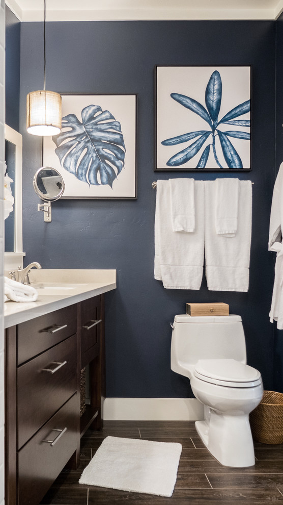 This is an example of a mid-sized beach style master bathroom in Hawaii with flat-panel cabinets, dark wood cabinets, a drop-in tub, a corner shower, white tile, subway tile, blue walls, ceramic floors and an undermount sink.