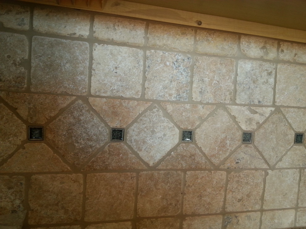 Example of a minimalist kitchen design in Atlanta with recessed-panel cabinets, dark wood cabinets, granite countertops, beige backsplash and stone tile backsplash