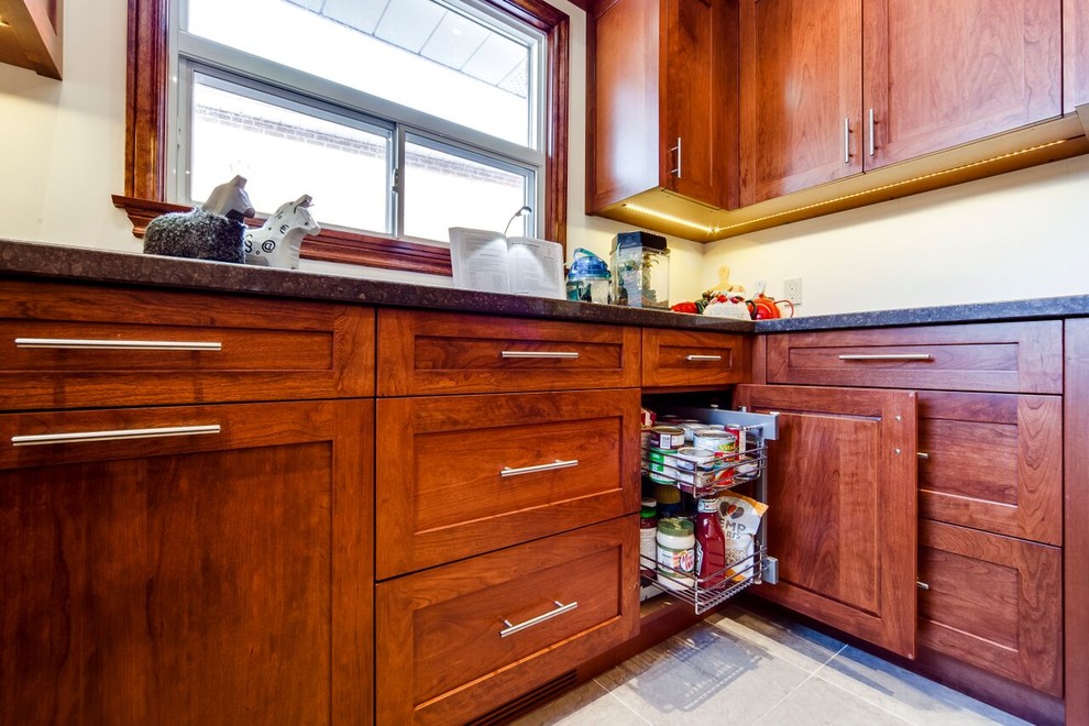 Example of a small transitional u-shaped ceramic tile enclosed kitchen design in Toronto with a double-bowl sink, shaker cabinets, medium tone wood cabinets, quartz countertops, yellow backsplash, black appliances and a peninsula