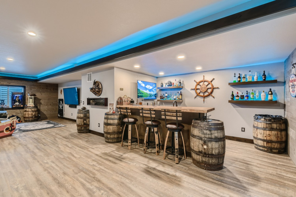Basement - large eclectic vinyl floor and gray floor basement idea in Denver with a bar and gray walls
