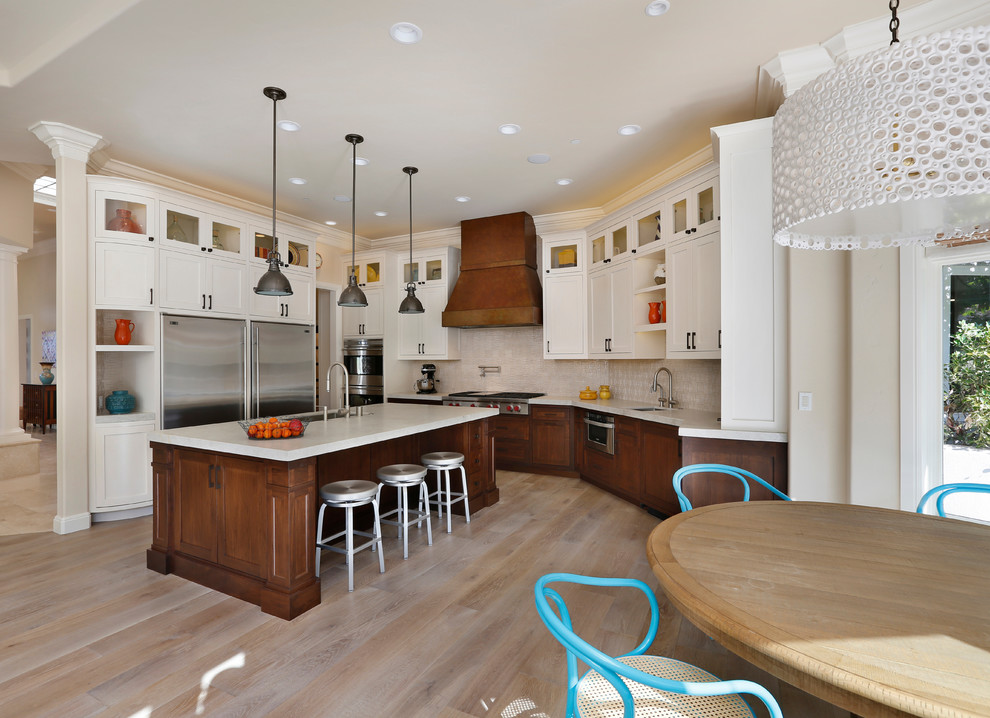 Photo of a transitional l-shaped eat-in kitchen in San Francisco with an undermount sink, shaker cabinets, dark wood cabinets and stainless steel appliances.