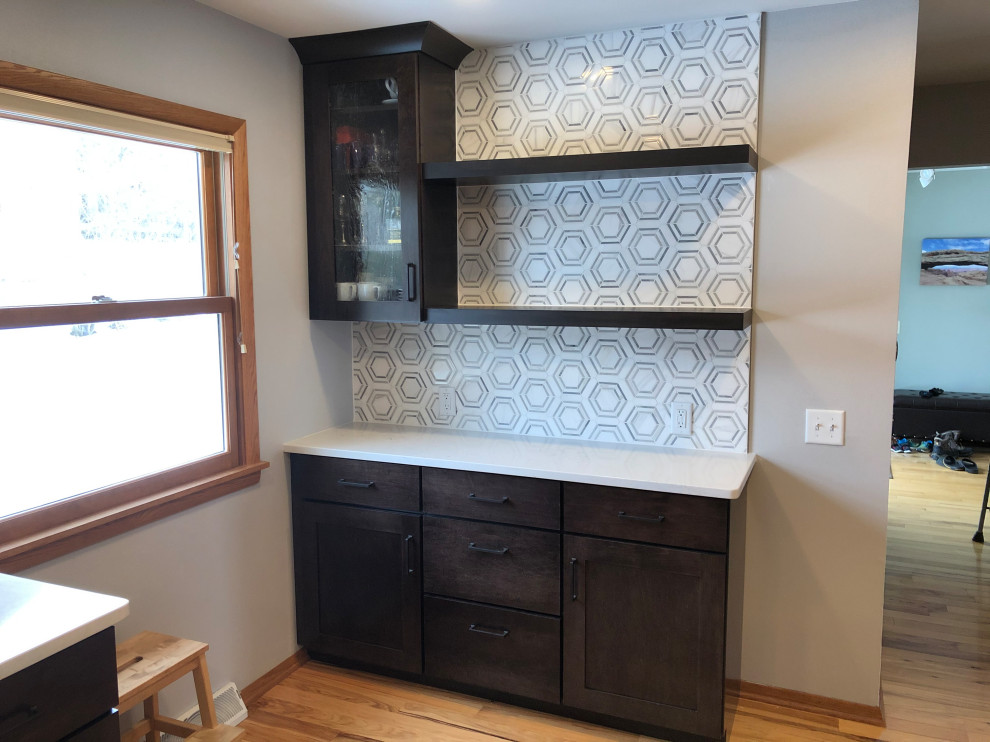 Eat-in kitchen - mid-sized transitional galley light wood floor and brown floor eat-in kitchen idea with an undermount sink, shaker cabinets, black cabinets, quartz countertops, gray backsplash, subway tile backsplash, stainless steel appliances, no island and white countertops