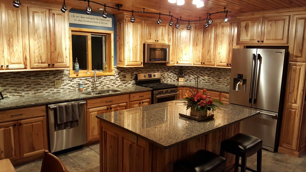 Inspiration for a mid-sized rustic l-shaped porcelain tile and gray floor eat-in kitchen remodel with a double-bowl sink, raised-panel cabinets, light wood cabinets, granite countertops, multicolored backsplash, matchstick tile backsplash, stainless steel appliances and an island
