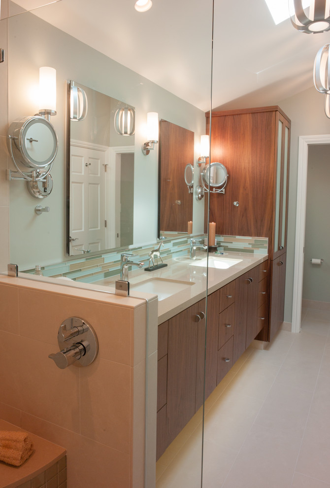 This is an example of a mid-sized contemporary master bathroom in San Francisco with an undermount sink, flat-panel cabinets, dark wood cabinets, engineered quartz benchtops, a double shower, a one-piece toilet, beige tile, porcelain tile, beige walls and porcelain floors.