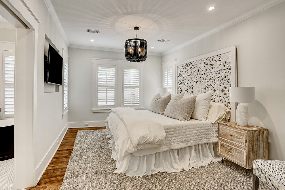 Transitional master bedroom in Houston with white walls, medium hardwood floors and brown floor.