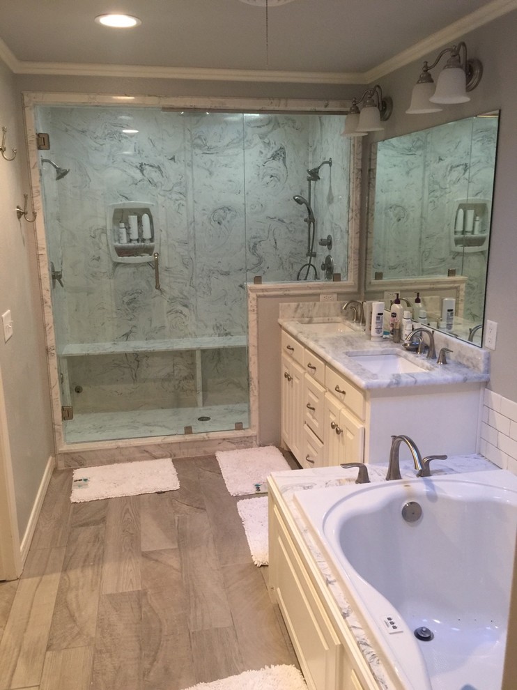 Design ideas for a mid-sized traditional master bathroom in Austin with white cabinets, an alcove shower, white tile, subway tile, grey walls, raised-panel cabinets, a hot tub, porcelain floors, an undermount sink and a hinged shower door.