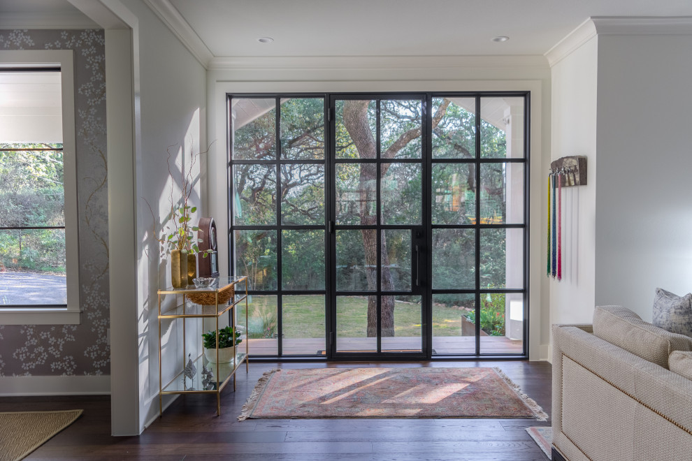 Example of a transitional dark wood floor and brown floor single front door design in Austin with white walls and a black front door