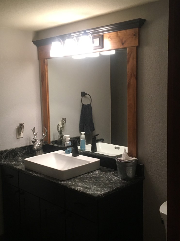 Bathroom - mid-sized rustic 3/4 bathroom idea with flat-panel cabinets, dark wood cabinets, a vessel sink and granite countertops