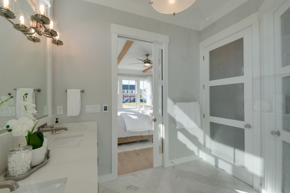 Photo of a mid-sized country master bathroom in Other with shaker cabinets, white cabinets, a double shower, a two-piece toilet, white tile, marble, grey walls, marble floors, an undermount sink, engineered quartz benchtops, white floor, a hinged shower door, white benchtops, a double vanity and a freestanding vanity.