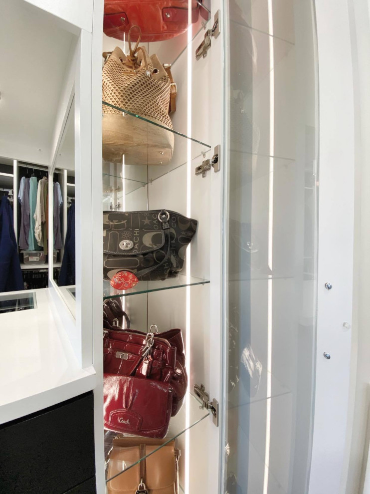 This is an example of a large transitional women's walk-in wardrobe in Other with shaker cabinets, white cabinets, carpet and grey floor.