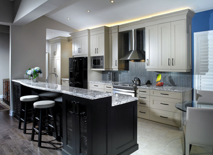 This is an example of a mid-sized contemporary single-wall eat-in kitchen in Toronto with an undermount sink, beige cabinets, granite benchtops, black appliances, ceramic floors, with island, grey splashback, matchstick tile splashback and shaker cabinets.