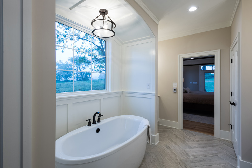 This is an example of a mid-sized arts and crafts master wet room bathroom in Other with recessed-panel cabinets, white cabinets, a freestanding tub, beige tile, glass tile, beige walls, ceramic floors, an undermount sink, granite benchtops, beige floor, an open shower and multi-coloured benchtops.