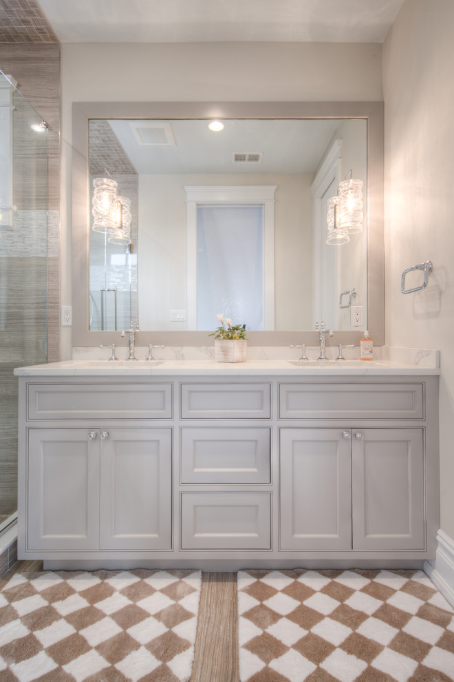 Mid-sized transitional master beige tile, brown tile, white tile and porcelain tile porcelain tile and multicolored floor alcove shower photo with shaker cabinets, white cabinets, beige walls, an undermount sink, quartz countertops and a hinged shower door