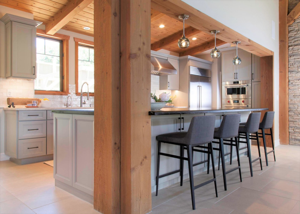 Open concept kitchen - large rustic galley porcelain tile, gray floor and wood ceiling open concept kitchen idea in Denver with an undermount sink, recessed-panel cabinets, gray cabinets, quartzite countertops, white backsplash, cement tile backsplash, stainless steel appliances, an island and white countertops