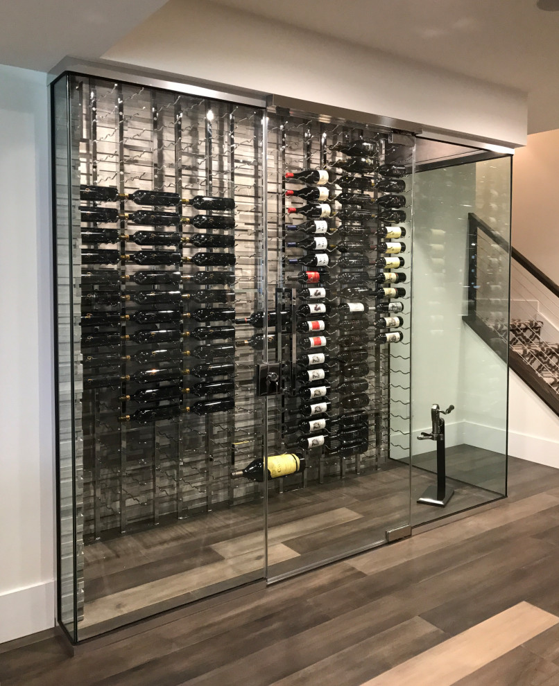 Inspiration for a mid-sized modern wine cellar in Philadelphia with medium hardwood floors, grey floor and display racks.