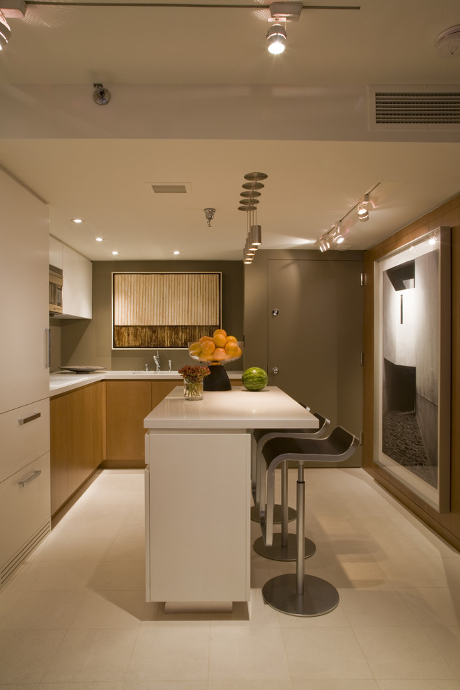 Contemporary l-shaped eat-in kitchen in DC Metro with an undermount sink, flat-panel cabinets, medium wood cabinets, quartz benchtops, panelled appliances, limestone floors, with island, white floor and white benchtop.