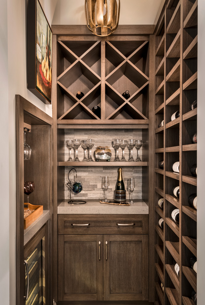 Inspiration for a small transitional wine cellar in Miami with porcelain floors, storage racks and beige floor.